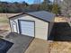 Tan metal garage with a light blue roll-up door at 291 Patterson Farm Rd, Mooresville, NC 28115