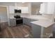 Modern kitchen with gray cabinets and quartz countertops at 291 Patterson Farm Rd, Mooresville, NC 28115