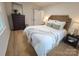 Cozy bedroom with wood-look floors, a dresser, and a rustic headboard at 301 W Hartford Ave, Bessemer City, NC 28016