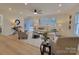 Light filled living room with L-shaped sofa, hardwood floors, and large windows at 301 W Hartford Ave, Bessemer City, NC 28016