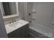 Modern bathroom with gray vanity and a bathtub at 303 Patterson Farm Rd, Mooresville, NC 28115