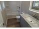 Clean bathroom with grey vanity, marble countertop, and tub at 303 Patterson Farm Rd, Mooresville, NC 28115