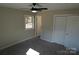 Spacious bedroom with gray carpeting and double doors at 303 Patterson Farm Rd, Mooresville, NC 28115