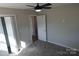 Bright bedroom with gray carpet and ceiling fan at 303 Patterson Farm Rd, Mooresville, NC 28115