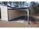 Metal carport attached to building providing covered parking at 303 Patterson Farm Rd, Mooresville, NC 28115