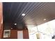 Dark wood-paneled covered patio ceiling with lighting at 303 Patterson Farm Rd, Mooresville, NC 28115