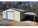 New metal garage with roll-up door and carport at 303 Patterson Farm Rd, Mooresville, NC 28115