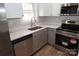 Modern kitchen featuring stainless steel appliances and quartz countertops at 303 Patterson Farm Rd, Mooresville, NC 28115