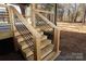 Wooden stairs with black metal railing leading to deck at 303 Patterson Farm Rd, Mooresville, NC 28115