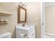 Clean bathroom with white vanity, gold accents, and framed mirror at 308 41St Avenue Nw Pl, Hickory, NC 28601