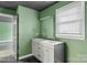 Basement bathroom with double vanity and green walls at 308 41St Avenue Nw Pl, Hickory, NC 28601