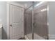 Bathroom with a shower featuring a glass door, tiled walls, and neutral-colored fixtures at 3575 Cerelia Ln, Denver, NC 28037