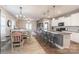 Open-concept dining area with wood floors and a view of a kitchen island and living room at 3575 Cerelia Ln, Denver, NC 28037