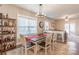 Bright dining room showcases a rustic dining table, modern chandelier, and beverage shelving at 3575 Cerelia Ln, Denver, NC 28037