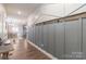 Entryway with gray wainscoting, a hall tree with hooks and wood flooring leading to dining room at 3575 Cerelia Ln, Denver, NC 28037