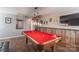 Entertaining game room with a stunning pool table set under a modern pendant light fixture at 3575 Cerelia Ln, Denver, NC 28037