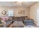 Relaxing living room showcasing a comfortable gray sectional sofa and decorative wall art at 3575 Cerelia Ln, Denver, NC 28037