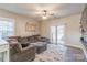 Inviting living room featuring a plush gray sectional sofa, ceiling fan, and sliding glass doors at 3575 Cerelia Ln, Denver, NC 28037