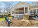 Private backyard with string lights, cozy seating, and a screened-in porch entrance at 3939 Sussex Ave, Charlotte, NC 28210