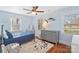 Charming bedroom with hardwood floors, ceiling fan, and an accent marlin on the wall at 3939 Sussex Ave, Charlotte, NC 28210