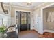 Entryway featuring a stylish table, and decorative mirror, adjacent to a paneled door at 3939 Sussex Ave, Charlotte, NC 28210