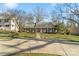 Inviting single-story home with a well-maintained lawn, mature trees, and a spacious driveway at 3939 Sussex Ave, Charlotte, NC 28210