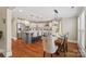 Elegant kitchen featuring white cabinets, stainless steel appliances, a large island, and a dining area at 3939 Sussex Ave, Charlotte, NC 28210