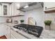 A well-equipped kitchen boasts white cabinets, granite countertops, stainless steel appliances, and a tiled backsplash at 3939 Sussex Ave, Charlotte, NC 28210