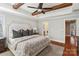 The main bedroom features wood floors, lots of natural light, an ensuite bathroom, and a decorative beam ceiling at 3939 Sussex Ave, Charlotte, NC 28210