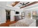 The main bedroom features a decorative wood beam ceiling, a walk-in closet, hardwood floors, and lots of natural light at 3939 Sussex Ave, Charlotte, NC 28210