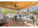 Relaxing screened-in porch with wooden ceiling, comfortable furniture, and a ceiling fan at 3939 Sussex Ave, Charlotte, NC 28210