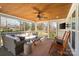 Relaxing screened-in porch with wooden ceiling, comfortable furniture, and a ceiling fan at 3939 Sussex Ave, Charlotte, NC 28210