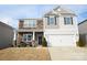 Two-story house with stone and siding, two-car garage, and landscaping at 4134 Richard Andrew Dr, Matthews, NC 28105