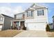 Two-story house with stone and siding, two-car garage, and landscaping at 4134 Richard Andrew Dr, Matthews, NC 28105