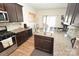 Kitchen with dark cabinets, granite countertops, and stainless steel appliances at 4134 Richard Andrew Dr, Matthews, NC 28105