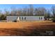 Gray mobile home with brick skirting, steps, and a small yard at 426 Sellerstown Rd, Kings Mountain, NC 28086