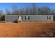 Gray mobile home with brick skirting, steps, and a small yard at 426 Sellerstown Rd, Kings Mountain, NC 28086