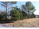 Partially cleared lot with mature trees bordering the property at 426 Sellerstown Rd, Kings Mountain, NC 28086