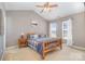 Bedroom with wood framed bed and two windows at 4301 Windjammer Sw Ct, Concord, NC 28027