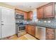 Well-equipped kitchen with stainless steel appliances and wood cabinets at 4301 Windjammer Sw Ct, Concord, NC 28027