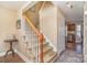 Elegant staircase with wooden railing leading to the upper level at 4301 Windjammer Sw Ct, Concord, NC 28027