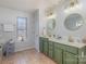 Bathroom featuring double sink vanity with decorative mirrors and a window at 4763 Brockton Nw Ct, Concord, NC 28027