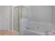 This bathroom features a soaking tub with gold hardware and a glass-enclosed shower at 4763 Brockton Nw Ct, Concord, NC 28027