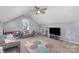 Spacious bonus room with ceiling fan, large windows, and a colorful area rug at 4763 Brockton Nw Ct, Concord, NC 28027