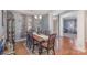 Dining room with wood floors, modern chandelier, and gray walls at 4763 Brockton Nw Ct, Concord, NC 28027