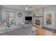 Living room with stone fireplace, hardwood floors, comfortable seating, and natural light at 4763 Brockton Nw Ct, Concord, NC 28027