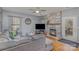 Comfortable living room features a stone fireplace, hardwood floors, and a ceiling fan at 4763 Brockton Nw Ct, Concord, NC 28027