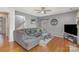 Comfortable living room featuring hardwood floors, ceiling fan, and a welcoming atmosphere for relaxation at 4763 Brockton Nw Ct, Concord, NC 28027