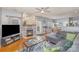 Inviting living room features a stone fireplace, hardwood floors, and seamless flow to kitchen and breakfast nook at 4763 Brockton Nw Ct, Concord, NC 28027