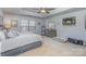 Relaxing main bedroom with tray ceiling, a large window, and a dresser at 4763 Brockton Nw Ct, Concord, NC 28027